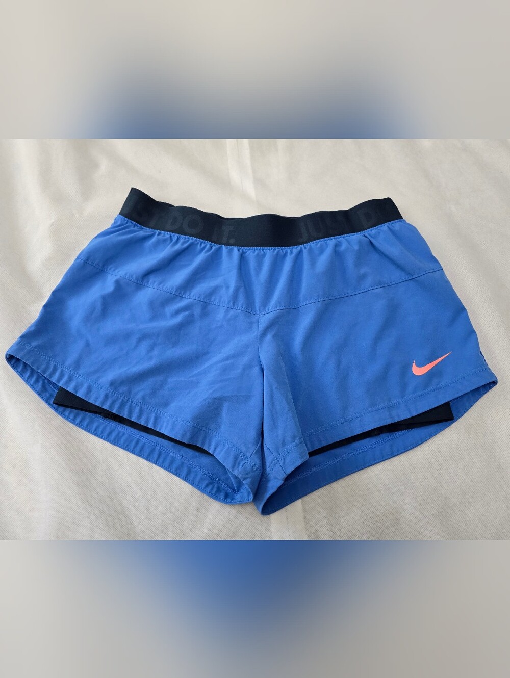 Nike Women's Blue Athletic Shorts with Black Waistband and Pink Swoosh